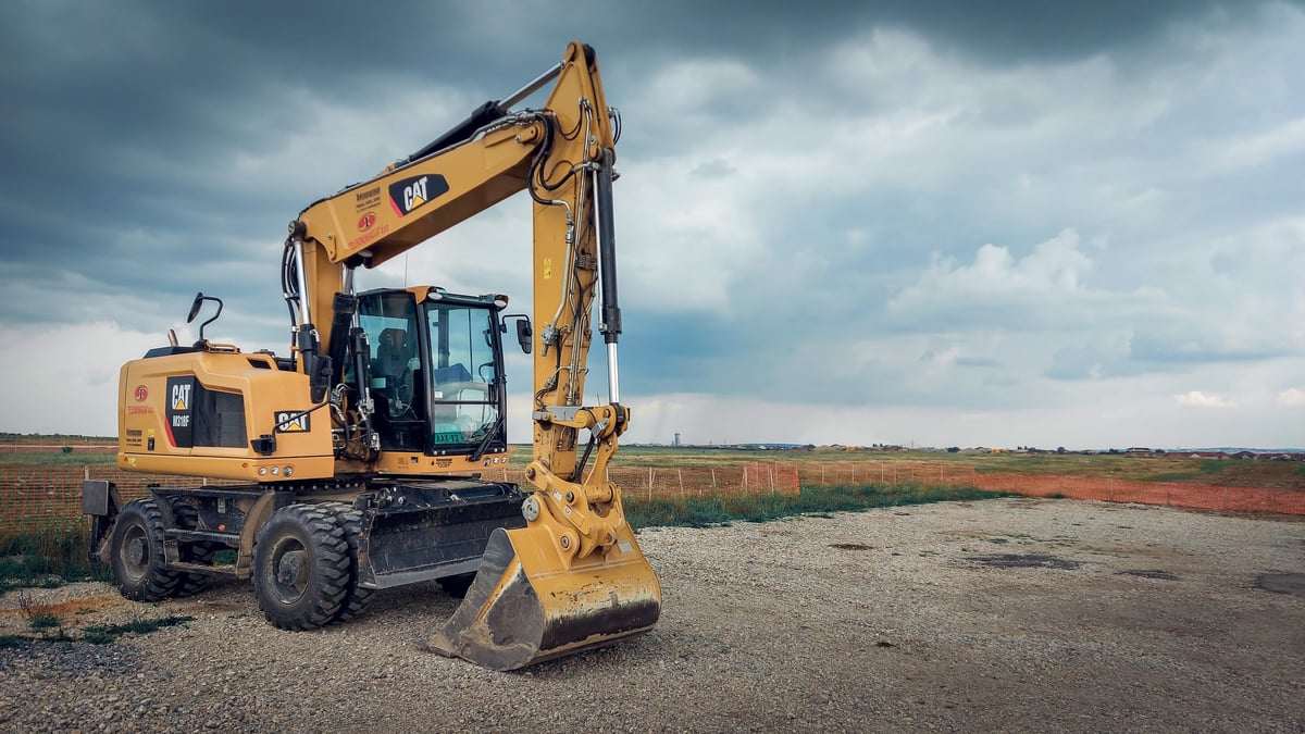 Yellow CAT excavator parked at a construction site