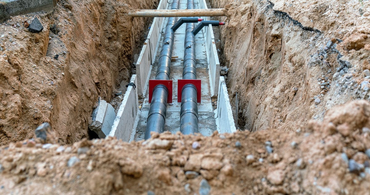 Underground pipes being installed in a trench